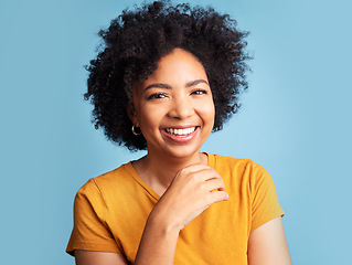 Image showing Happy, smile and portrait of a woman in a studio with a positive, good and confident mindset. Happiness, excited and headshot of a young female model with an afro from Colombia by a blue background.