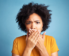 Image showing Surprise, shock and portrait of a woman in studio with a wtf, omg or wow face expression. Shocked, emotion and headshot of young female model with scared gesture or emoji isolated by blue background.