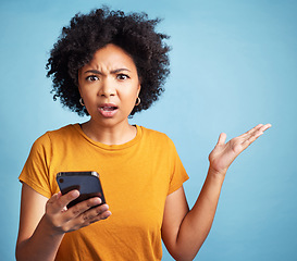Image showing Confused, phone and woman portrait isolated on blue background for college doubt, decision or questions. Stress, surprise and young person or student in what or why hand for mobile problem or choice