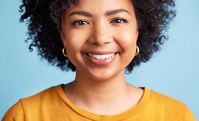 Image showing Happy, woman and portrait with natural beauty, confidence or makeup on studio blue background. Face, happiness or person with African hair, afro or smile in salon for hairstyle care or skincare