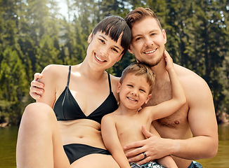 Image showing Portrait, family and smile at lake with swimwear on vacation, summer holiday or travel. Face, happy and man, woman and child with swimsuit at river for fun, bonding and enjoying quality time together