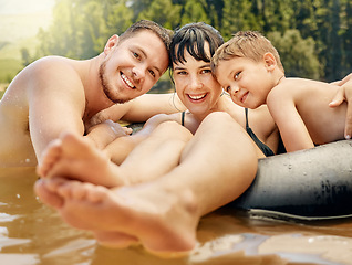 Image showing Family, portrait and swimming in lake with happiness in nature, parents and child on summer vacation. Tube, adventure and fun outdoor with man, woman and boy in water with smile, travel and holiday