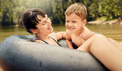 Image showing Lake, swimming and parent with kid in water while camping in a forest for vacation or holiday together. Travel, swimming and mother bonding with child in nature for freedom, love and happiness