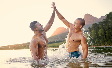 Image showing Lake, high five and swimming with man friends outdoor in nature for travel or adventure while on summer holiday. Motivation, water or wet with a young male traveler and best friend on vacation