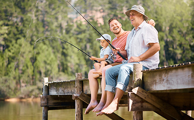 Image showing Happy father, grandfather and child fishing at lake together for fun bonding or peaceful time in nature. Dad, grandpa and kid enjoying life, catch or fish with rod by water pond or river in forest