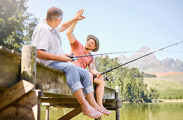 Image showing Happy man, father and high five for fishing in lake for successful catch, bonding or winning together in nature. Elderly male person with son in victory, fish or achievement on forest holiday weekend