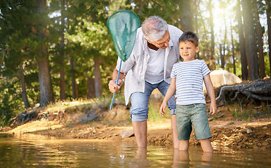 Image showing Camp, child with grandfather and with fishing net at the lake in the forest outdoor with a lens flare. Happy or freedom, adventure or nature and people bonding together for health wellness at river