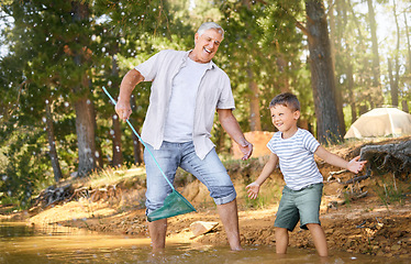 Image showing Happy, grandparent teaching child with fishing net and at lake with a lens flare in forest for support. Camp or freedom, collaboration or teamwork and people learning how to fish together at river