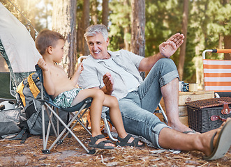 Image showing Child, senior man and camping outdoor in nature with a smile, fun and family travel for summer holiday. Happy grandpa and kid camper talking at a camp site, forest or woods with love for adventure