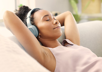 Image showing Music headphones, meditation and woman on sofa in home living room for streaming. Relax, couch and African person listening to radio, audio or podcast, jazz and sound for calm, peace or mindfulness.