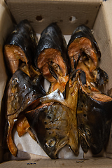 Image showing Smoked fish in craft paper box.