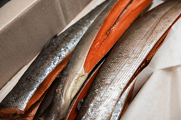 Image showing Smoked fish in craft paper box.