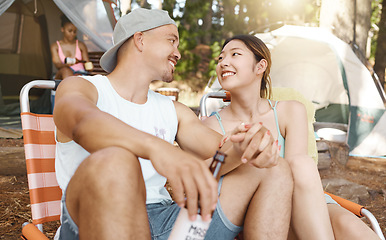 Image showing Camping, love and a young couple in nature while in the forest or woods for travel and adventure. Hiking, relax and a man with his girlfriend drinking beer at their campsite outdoor in the wilderness