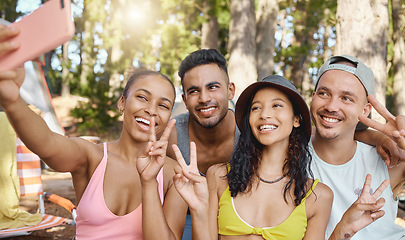 Image showing Peace sign, smile and selfie of friends camping in forest, woods or nature together. Happy, v hand and people taking picture for hiking, social media emoji or group memory outdoor on summer vacation.