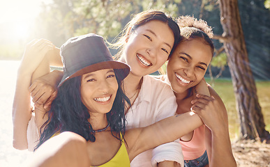 Image showing Friends, portrait and happiness, camping in the woods with adventure and diversity, hug and people have fun together outdoor. Forest, sunshine and travel, young women with smile and freedom in summer