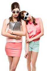 Image showing Fashion, friends and retro with portrait of women in studio for elegant, pastel and beauty. Sunglasses, confident and cosmetics with people isolated on dark background for glamour, beehive and style