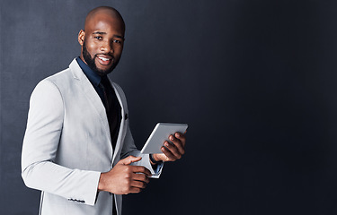 Image showing Portrait, tablet and business man isolated on dark gray background and mockup for financial news or information. Face of corporate african person or accountant in suit on digital tech and banner wall