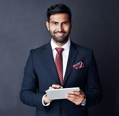 Image showing Businessman, tablet and smile in studio, dark background or research stock market trading news online. Corporate trader, indian man or digital technology for investment management, finance or website