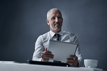 Image showing Tablet, office and business man online for social media, internet and browse website at desk. Thinking, corporate worker and happy mature male person on digital tech for message, email and planning
