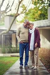 Image showing Happy senior couple, garden and hug with smile, walk and together with love, bonding or freedom in winter. Old woman, man and embrace with care in backyard in retirement, nature or outdoor in morning