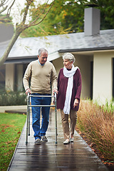 Image showing Senior couple, garden and walker with chat, listen or together for love, bond or freedom in winter. Old woman, support and elderly person with disability in backyard, retirement or outdoor in morning