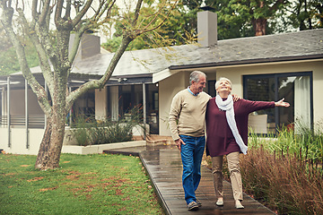 Image showing Senior couple, garden and walk with smile, hug and together with love, bonding and freedom in winter morning. Old woman, happy man and embrace in backyard in retirement, nature and outdoor with chat