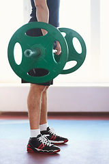 Image showing Man, shoes and hands weightlifting in a gym with athlete wellness and healthy from workout. Fitness, bodybuilder and male person with weights power from strong arm muscle and training at health club