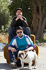 Image showing Portrait, retro style and dog with friends and their pet outdoor in a downtown neighborhood together. Street, fashion and culture with men and their bulldog puppy on an urban background