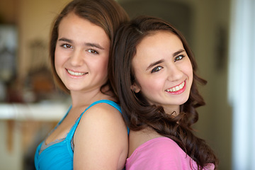 Image showing Happy sisters, portrait and standing back to back for family, friends or teens together at home. Face of female people, siblings and smile for friendship, relationship or young women in the house