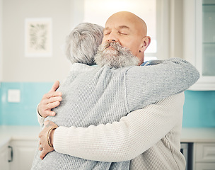 Image showing Love, romance and senior couple hugging in the kitchen together in their modern house. Happy, sweet and elderly man embracing his wife with care, affection and happiness for bonding in their home.