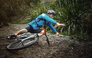 Image showing Man, mountain bike and woods with falling, ground and fitness for training, workout and red glow for injury. Forest cycling, guy and joint pain with bicycle, accident and riding outdoor in nature