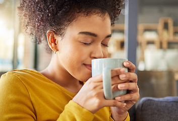 Image showing African woman, coffee cup and smell on sofa, flavor and energy to start morning in apartment. Girl, happy and drink to relax with tea, matcha or espresso with fragrance, thinking and mug in house