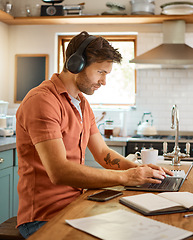 Image showing Remote work, laptop and headphones, man in kitchen typing email, social media post or networking for online job. Technology, streaming and freelancer on internet writing blog or article with music.