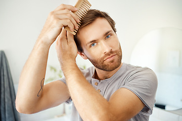 Image showing Bathroom portrait, brush and man with hair care maintenance, texture grooming or morning cleaning routine. Salon, home face and person with eco friendly bamboo comb for healthy hairstyle treatment