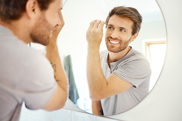 Image showing Man, tweezer and eyebrow in bathroom mirror with smile, self care and hygiene to start morning in home bathroom. Young guy, person and tool for beauty, facial cosmetics and wellness for hair removal