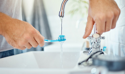 Image showing Hands, toothbrush and person at tap for water, dental hygiene and gum care at home. Closeup, brushing teeth and rinse oral product for fresh grooming, morning routine and cleaning at bathroom sink