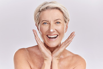 Image showing Skincare, portrait and mature woman with cream on face for anti aging, dermatology and collagen on white background. Facial, happy senior model with lotion or sunscreen in studio with beauty product.