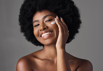 Image showing African woman, skincare cream or studio portrait with afro, face or cosmetic for smile by background. Girl, model and happy for natural self care with makeup, clean aesthetic and product for beauty