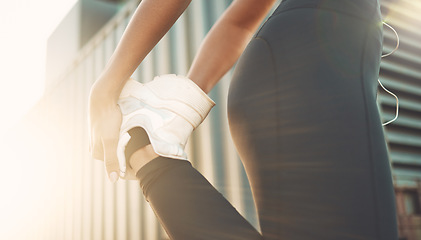 Image showing Fitness, feet and woman stretching legs in city for wellness, workout and balance in town. Sports, healthy body and closeup of female person outdoors for exercise, training and warm up for running