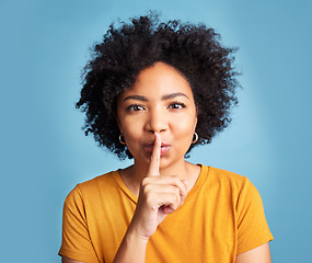 Image showing Secret, quiet and shush with portrait of woman in studio for noise, privacy and gossip. Communication, announcement and whisper with face of person on blue background for voice, sign and rumor