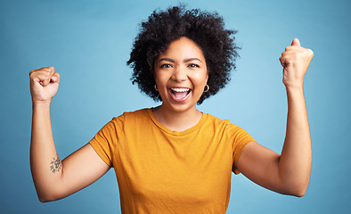 Image showing Winner portrait, yes and woman isolated on blue background in winning, success and news or college opportunity. Celebrate, fist or power of african person or excited student energy or goals in studio