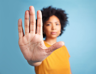 Image showing Portrait, stop hand sign and woman in studio isolated on a blue background mockup space. African person, face and ban, rejection or warning, refuse or no palm to protest racism, human rights or emoji