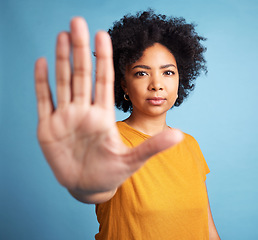 Image showing Stop hand, serious woman and portrait in studio isolated on a blue background. African person, face and ban, rejection or warning, refuse and no palm sign to protest racism, human rights and emoji.