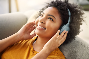 Image showing Headphone, music and radio with girl on sofa for relaxing at apartment with smile on weekend. Song, woman and lying on coach with earphone with thinking for streaming with peace and calm at house.