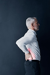 Image showing Injury, feeling and a businessman with back pain at work, spine problem and tired from stress. Serious, backache and a mature corporate employee touching body isolated on a black background in studio
