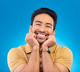 Image showing Happy, excited man and cute smile portrait in studio with Asian model with teeth and joy. Blue background, male person and casual fashion with handsome and friendly guy with modern style and wow face