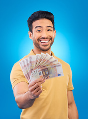 Image showing Money fan, portrait and man or winner with bonus offer, financial success and winning, finance loan or lottery. Asian person with savings, winning cash and profit isolated on studio, blue background