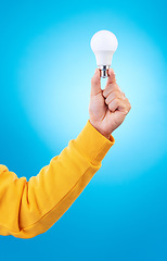 Image showing Thinking, lightbulb ideas and hands of person with solution, problem solving plan or strategy development. Innovation, light bulb and studio model with entrepreneurship inspiration on blue background