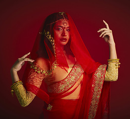 Image showing Fashion, beauty and portrait of Indian woman with veil in traditional clothes, jewellery and sari. Religion, culture and face of female person on red background with accessory, cosmetics and makeup