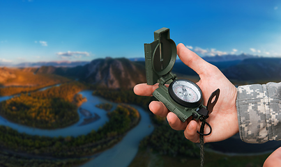 Image showing Man with compass n Altai mountains